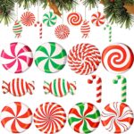 A cluster of red, white, and green striped wooden candy cane ornaments hanging from a Christmas tree branch.