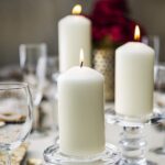 A set of 12 ivory BOLSIUS pillar candles, each 2.7x5 inches, standing upright, ready for use as elegant decor.