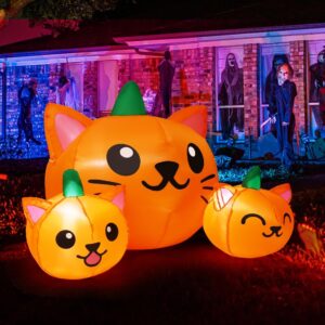 A 5-foot long Halloween inflatable featuring three orange and green pumpkin cat heads with bright white LED lights, set up ou