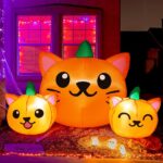 A 5-foot long Halloween inflatable featuring three orange and green pumpkin cat heads with bright white LED lights, set up ou