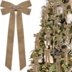 A close-up view of multiple light brown velvet ribbon bows, some hanging on a Christmas tree with soft, blurred lights in the