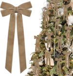 A close-up view of multiple light brown velvet ribbon bows, some hanging on a Christmas tree with soft, blurred lights in the