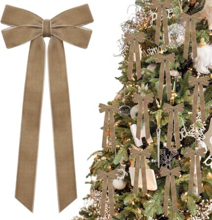A close-up view of multiple light brown velvet ribbon bows, some hanging on a Christmas tree with soft, blurred lights in the