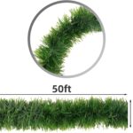 A long, lush green tinsel Christmas garland, non-lit, draped over a mantelpiece with a fireplace below.
