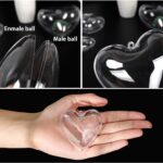A group of ten clear plastic heart-shaped ornaments, some open to show their fillable design, ready for crafting.