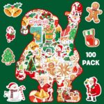 A close-up view of Masper 100 non-repeating glitter Christmas stickers featuring various holiday designs like Santa, reindeer