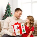 A close-up view of Masper 100 non-repeating glitter Christmas stickers featuring various holiday designs like Santa, reindeer