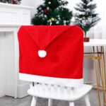 A set of 10 red Santa hat-shaped chair back covers, festive and ready for Christmas holiday party decorations.
