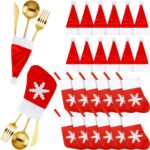 Close-up of red and white non-woven Christmas mini Santa hats and stocking silverware holders on a holiday table.