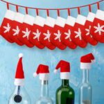 Close-up of red and white non-woven Christmas mini Santa hats and stocking silverware holders on a holiday table.