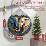 A close-up of a Touber elephant stained glass Christmas ornament hanging from a tree branch, showcasing its vibrant colors.