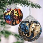 A close-up of a Touber elephant stained glass Christmas ornament hanging from a tree branch, showcasing its vibrant colors.
