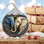 A close-up of a Touber elephant stained glass Christmas ornament hanging from a tree branch, showcasing its vibrant colors.