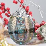 A close-up of a Touber stained glass owl Christmas ornament with intricate details and vibrant colors, hanging by a ribbon.