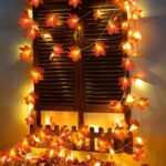 Two strands of TURNMEON fall garlands, each with 40 enlarged orange and yellow maple leaves and warm white LED lights, draped